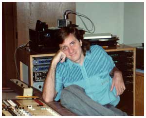 a guy siting in a recording studio